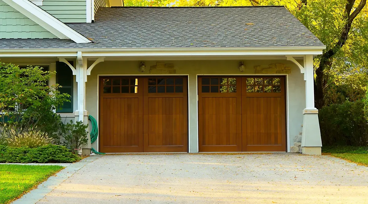 Certified Denver garage door technician performing 25-point physical safety inspection on residential overhead door